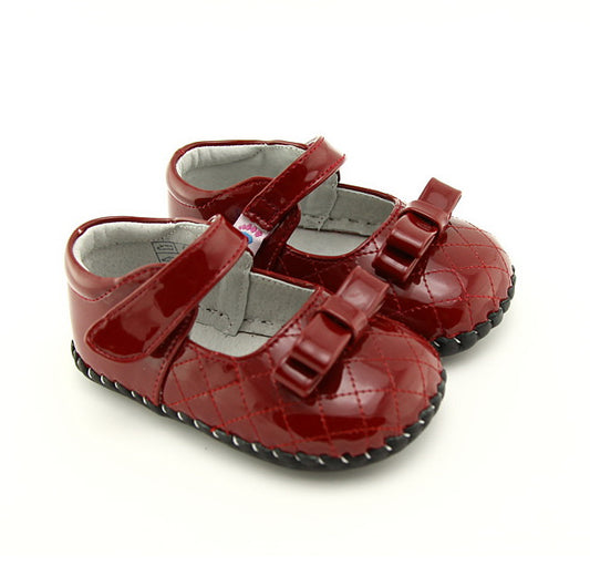 Red Mary Jane kids shoes with buckle straps and a glossy finish