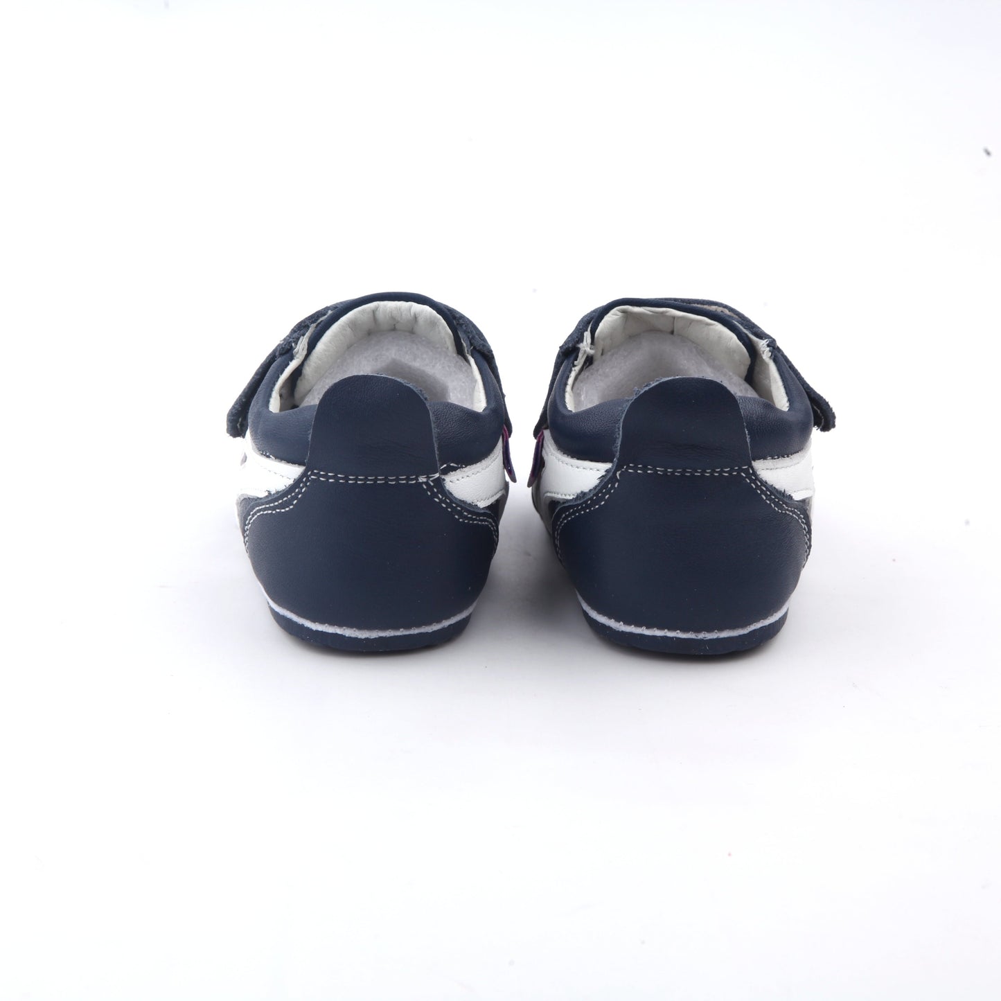 back view of navy leather baby shoes with white side stripe and velcro closures