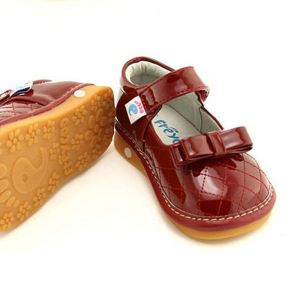 Shiny red Mary Jane shoes with squeaker and bow
