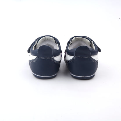 back view of navy leather baby shoes with white side stripe and velcro closures