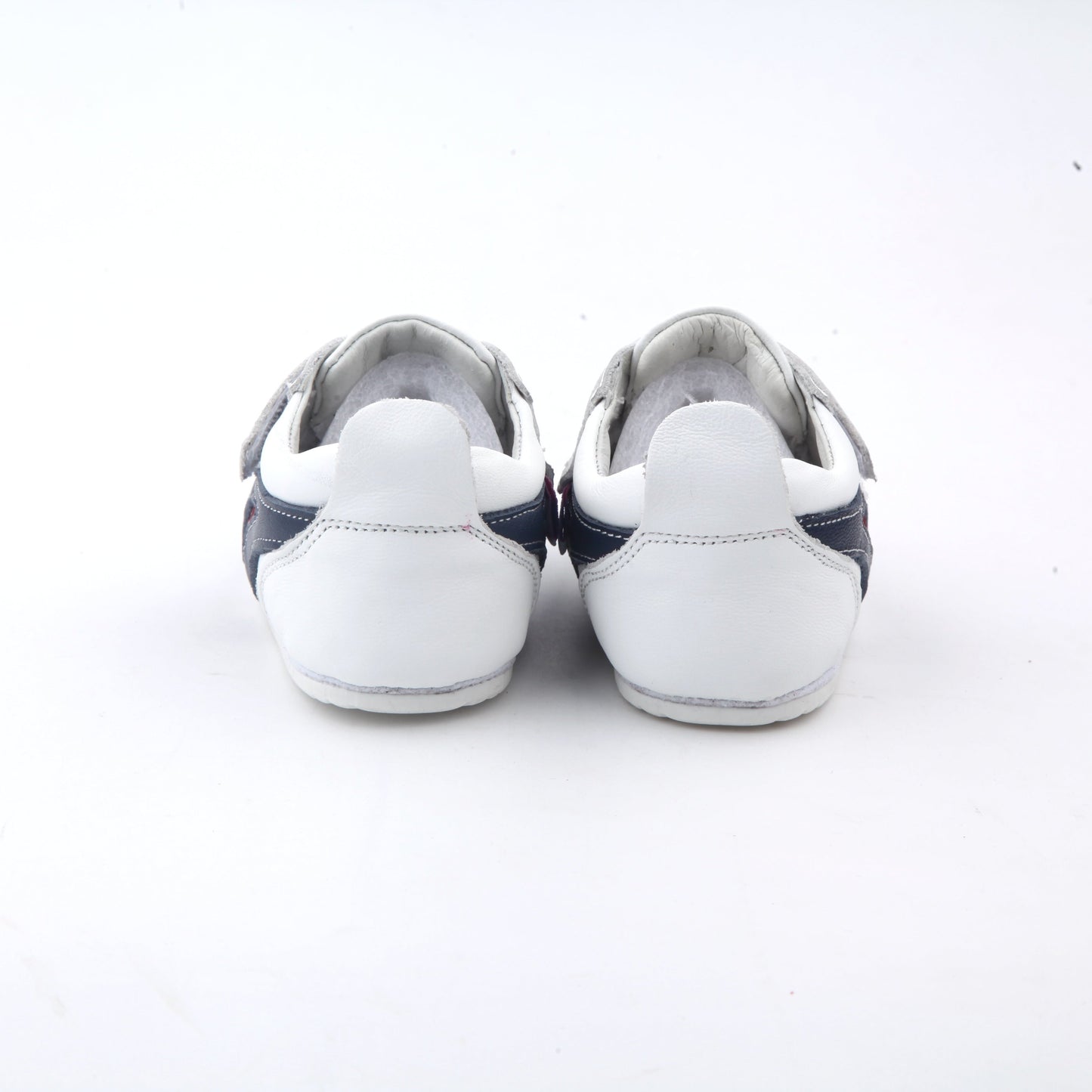 white kids sneakers and velcro straps